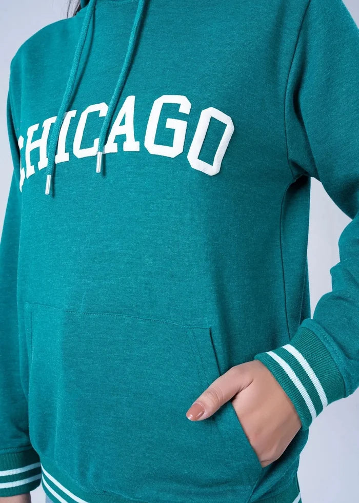Women's teal terry hoodie close-up: CHICAGO logo and front kangaroo pocket