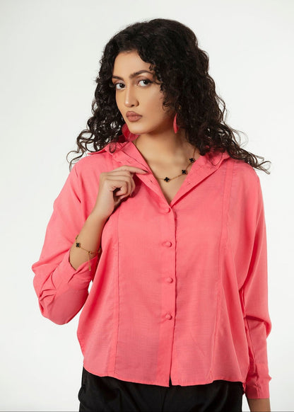 Women's pink button-up shirt with pointed collar, front close-up and long sleeves