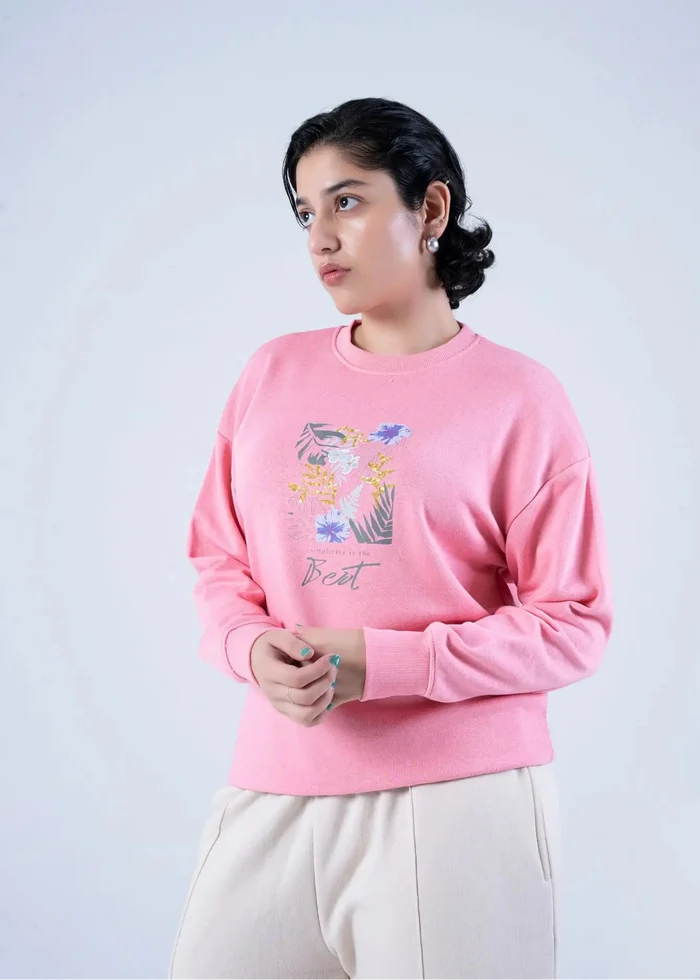 Women's pink crewneck knit sweatshirt with floral graphic front, long sleeves