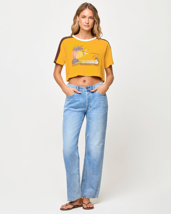 Front view of model wearing the LSPACE x The Salty Blonde Costa Crop Top in cabo sunset, a cropped top in a warm sunset colorway.