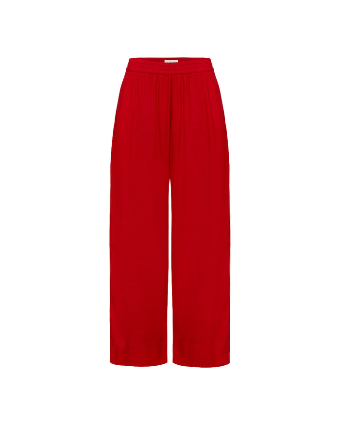Off-model view of the LSPACE x The Salty Blonde Sur Pant in flame-cream, displayed flat to show the wide-leg silhouette and gathered waistband in flame red.